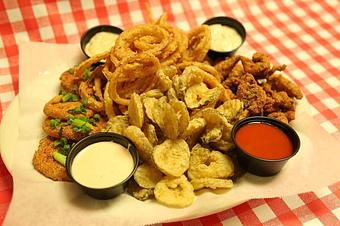 Product: Can't decide? Just them all in one with the Caney sampler. Onion rings, pickle chips, fried green tomatos, and your choice of either wings or catfish bites! - Caney Fork River Valley Grille in Nashville, TN American Restaurants