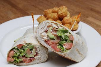 Product: Turkey Avocado Wrap shown with Tator Tot side option - Cavanaugh's Rittenhouse in Rittenhouse Square - Philadelphia, PA Bars & Grills