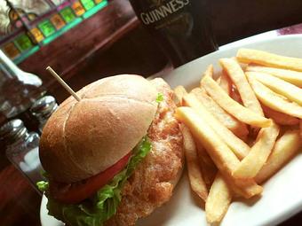 Product: A filet of Icelandic Cod in a grilled, toasted artisan bun, with fresh lettuce and tomato. Served with chips (fries). - Celtic Ray Irish Pub in Punta Gorda Downtown Historic Distrcy - Punta Gorda, FL Bars & Grills