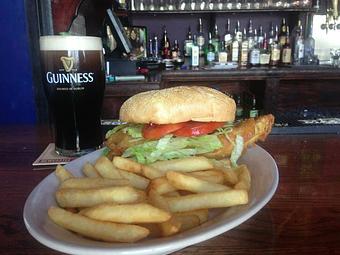 Product: A filet of Icelandic Cod in a grilled, toasted artisan bun, with fresh lettuce and tomato. Served with chips (fries). - Celtic Ray Irish Pub in Punta Gorda Downtown Historic Distrcy - Punta Gorda, FL Bars & Grills