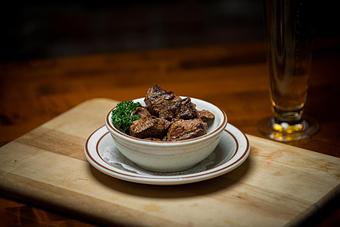 Product: A bowl of lightly blackened Angus sirloin tips  (While they last) - Chuck's Steak House in Restaurant Row - Myrtle Beach, SC Steak House Restaurants