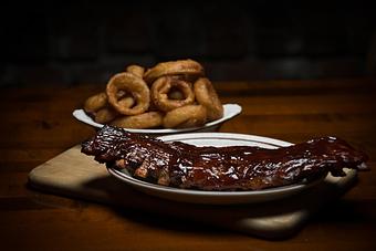 Product: Tender, meaty, tangy and tasty finger licking pork ribs. - Chuck's Steak House in Restaurant Row - Myrtle Beach, SC Steak House Restaurants
