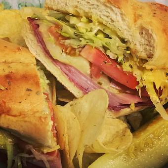 Product: Our famous Italian sub with Genoa salami, black forest ham and provolone cheese, topped with peppers, onions, tomatoes, lettuce and a creamy Italian dressing.  Won't find another like this anywhere around! - Difilippo's Pizza in Ozark, AL Pizza Restaurant