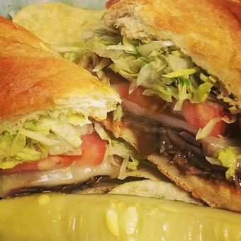 Product: Roast beef covered with brown gravy and provolone cheese and topped with lettuce and tomatoes - Difilippo's Pizza in Ozark, AL Pizza Restaurant