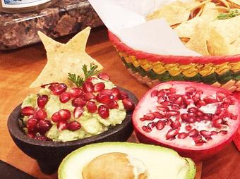 Product: Daily Fresh made Guacamole, topped with seasonal fruit.  Pomegranate (winter/fall) Mango (Summer/Spring) - Estrella Negra in Logan Square/ Bucktown border - Chicago, IL Latin American Restaurants