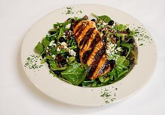 Product: Grilled salmon on a bed of field greens with blueberries, pecans, bleu cheese crumbles & vinaigrette dressing. - Eugene's Gulf Coast Cuisine in Houston, TX Seafood Restaurants