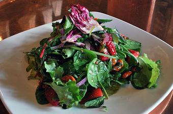 Product: Mizuna and baby greens with red raspberry mirin vinaigrette, raspberries, strawberry, red onions and 5 spiced candied cashews - Fats Asia Bistro in Roseville - Roseville, CA Chinese Restaurants