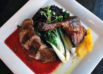 Product: Confit leg with orange sake sauce and seared breast with raspberry plum wine sauce, served over Firecracker black rice with baby bok choy. - Fats Asia Bistro in Roseville - Roseville, CA Chinese Restaurants