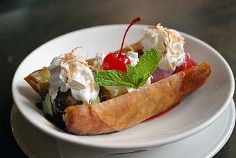 Product: Our house-made banana spring roll, flash fried and served with Gunther's Ice Cream trio of flavors of the day. Topped with pineapple, strawberry and chocolate sauces, whipped cream, toasted coconut and finished with a cherry. - Fats Asia Bistro in Roseville - Roseville, CA Chinese Restaurants