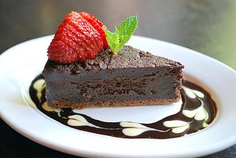 Product: Our house-made flour-less chocolate cake served with chocolate and creme anglaise sauce. - Fats Asia Bistro in Roseville - Roseville, CA Chinese Restaurants