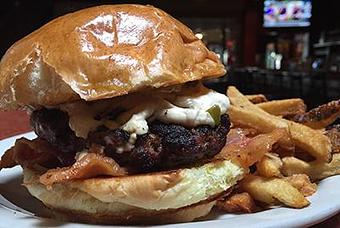 Product: Bacon Burger with local green tomato, apple jam, bacon and jalapeño goat cheese on a brioche bun. - Foothills Brewing in Winston Salem, NC American Restaurants