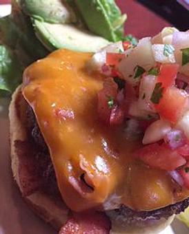 Product: Blackened burger topped with pineapple, pico de gallo, avocado, smoked bacon cheddar cheese and crispy bacon. - Foothills Brewing in Winston Salem, NC American Restaurants