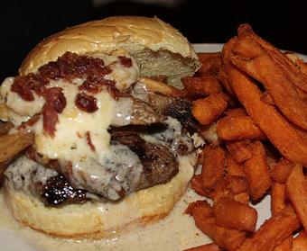 Product: Cheese curds, bacon and gravy on brioche. Served with French fries. - Foothills Brewing in Winston Salem, NC American Restaurants