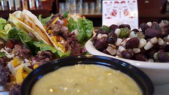 Product: Steak Tacos with Pico de Gallo, smoked beans, lettuce, loaded with cheeses and sauce. - Foothills Brewing in Winston Salem, NC American Restaurants