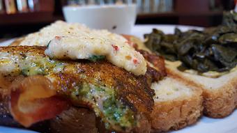 Product: Blackened chicken breast topped with pimento cheese, bacon, collards and brown mustard on jalapeno cornbread. - Foothills Brewing in Winston Salem, NC American Restaurants