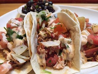 Product: Slow roasted pulled chicken topped with chipotle ranch and grilled cantaloupe pico - Foothills Brewing in Winston Salem, NC American Restaurants