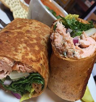 Product: House smoked salmon, dill cream cheese, capers, red onion and romaine in a tomato basil wrap - Foothills Brewing in Winston Salem, NC American Restaurants