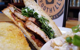 Product: Pork loin, whole grain mustard, sweet goat cheese spread, arugula and bacon on sourdough - Foothills Brewing in Winston Salem, NC American Restaurants
