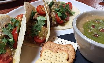 Product: Beer braised pulled pork, salsa verde, grape tomatoes, and cilantro - Foothills Brewing in Winston Salem, NC American Restaurants