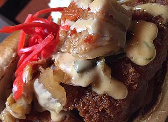 Product: Panko crusted fried pork chop with house made kimchi, yum yum sauce and pickled ginger - Foothills Brewing in Winston Salem, NC American Restaurants