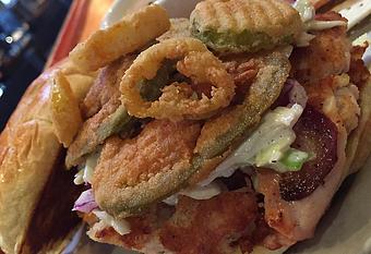 Product: Smoked chicken patty with Alabama white BBQ slaw, fried banana peppers, jalapeno and pickle chip medley - Foothills Brewing in Winston Salem, NC American Restaurants