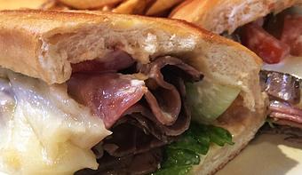 Product: Roast beef served warm with Swiss cheese, lettuce, tomato and horsey sauce on a hoagie - Foothills Brewing in Winston Salem, NC American Restaurants