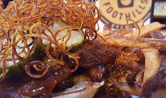 Product: Smoked ribs, gochujang sauce, pickle chips topped with a fried sweet potato nest - Foothills Brewing in Winston Salem, NC American Restaurants