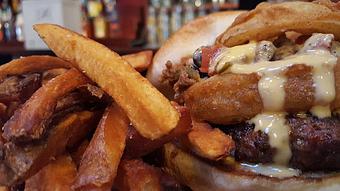 Product: Buffalo burger topped with an onion ring, chili and beer cheese - Foothills Brewing in Winston Salem, NC American Restaurants