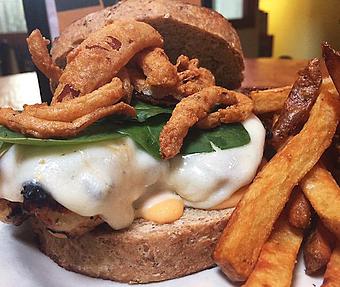 Product: Grilled chicken, provolone, spinach, fried onion straws and sun dried tomato aioli - Foothills Brewing in Winston Salem, NC American Restaurants