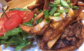 Product: Braised top round, loaded cheese fries, lettuce, tomato and ranch - Foothills Brewing in Winston Salem, NC American Restaurants