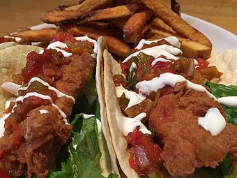 Product: Fried Pollock Tacos, with green chili salsa, lettuce and lime sour cream - Foothills Brewing in Winston Salem, NC American Restaurants