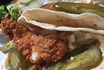 Product: Buttermilk fried pork chop with Napa slaw, and pickled jalapeños - Foothills Brewing in Winston Salem, NC American Restaurants