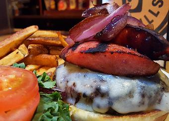 Product: Beef burger topped with smoked sausage, swiss cheese - Foothills Brewing in Winston Salem, NC American Restaurants