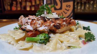 Product: Blackened chicken alfredo, with broccoli, and roasted red pepper, over bowtie pasta - Foothills Brewing in Winston Salem, NC American Restaurants
