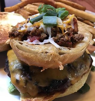 Product: Carolina burger with chili, cheddar, scallions and topped with an onion ring - Foothills Brewing in Winston Salem, NC American Restaurants