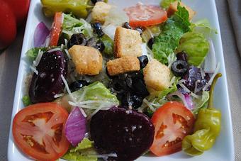 Product: Italian House Salad with Romaine lettuce, tomatoes, sweet pickled beets, pepperoncini, red onions, Parmesan cheese, black olives & croutons served with your choice of dressing. - Franco's Pizza in Lawrenceville, GA Pizza Restaurant