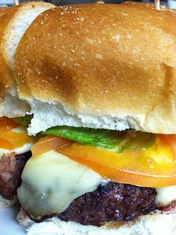 Product: Juicy burger topped with your choice of melted cheddar, American, Swiss or mozzarella, Bermuda onion, lettuce & tomato. - Gaetano's Tavern On Main in Wallingford, CT American Restaurants