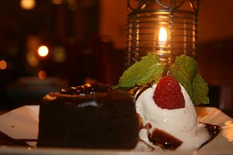 Product: Warm Chocolate Cake w/ Vanilla Bean Ice Cream - Garden Cafe in Inwood section of Washington heights - New York, NY American Restaurants