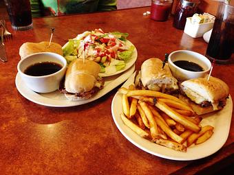 Product: Lunch Special, French Dip. Delicious Roast Beef with Sauteed Onions and Jack Cheese on House Made French Roll with Au Jus and your choice of side - Gillwoods Cafe in Saint Helena, CA American Restaurants