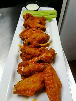 Product: Plump juicy wings tossed in a secret sauce made with Irish whiskey and served with celery and blue cheese - Harp & Celt Irish Pub & Restaurant in Central Business District - Orlando, FL Pubs