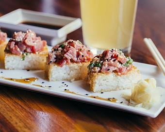 Product: four crispy rice squares are topped with raw ahi tuna, tobanjan mayo and sesame seeds. topped with scallions and soy ginger dressing - Hub 51 in River North - Chicago, IL American Restaurants