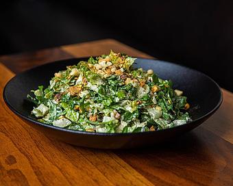 Product: a twist on a classic caesar. romaine and arugula are tossed with housemade caesar dressing, toasted pistachios, parmesan cheese and crispy crumbled bread crumbs - Hub 51 in River North - Chicago, IL American Restaurants