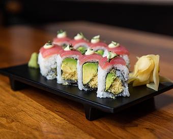 Product: nori seaweed wrapped with sushi rice, avocado and fried tempura bits. topped with sliced ahi tuna, wasabi mayo and thai basil. sliced into eight pieces and served with soy sauce, pickled ginger and wasabi - Hub 51 in River North - Chicago, IL American Restaurants