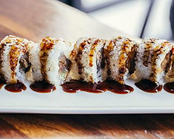 Product: nori seaweed wrapped with sushi rice, spicy tuna mix, siracha and chili oil. crusted with fried tempura bits and topped with japanese bbq sauce. sliced into eight pieces and served with soy sauce, pickled ginger and wasabi - Hub 51 in River North - Chicago, IL American Restaurants