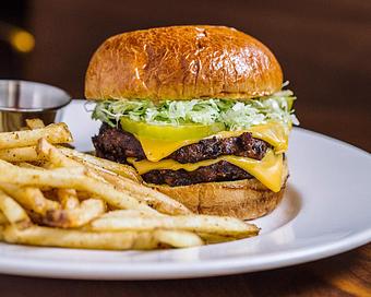 Product: two veggie patties are grilled over an open flame and come with american cheese, lettuce, pickles, cholula hot sauce, mustard and our "special sauce". served with french fries - Hub 51 in River North - Chicago, IL American Restaurants