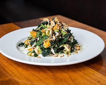 Product: chopped kale is tossed with mustard vinaigrette, shredded green cabbage, orange, avocado and red quinoa. finished with roasted cashews - Hub 51 in River North - Chicago, IL American Restaurants
