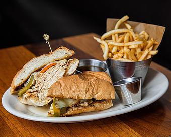 Product: slow roasted chicken breast is sliced and served on a baguette with melted provolone and sweet peppers. served with au jus for dipping, giardinera and french fries - Hub 51 in River North - Chicago, IL American Restaurants