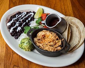 Product: build-you-own tacos are served with braised and pulled chicken, white rice, black beans, sour cream, pico de gallo, guacamole, cilantro, roasted tomato salsa and corn tortillas - Hub 51 in River North - Chicago, IL American Restaurants