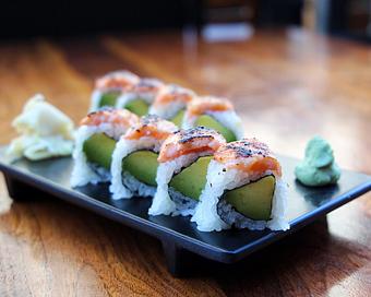 Product: nori seaweed wrapped with sushi rice, cucumber and avocado. topped with miso-marinated salmon and torched. sliced into eight pieces and served with soy sauce, pickled ginger and wasabi - Hub 51 in River North - Chicago, IL American Restaurants