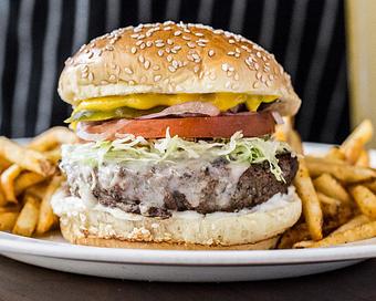 Product: our burger is grilled over an open flame and comes with yellow mustard, mayo, lettuce, tomato, pickle and onion. served with your choice of cheese (american, white cheddar, provolone or blue cheese crumbles) and french fries - Hub 51 in River North - Chicago, IL American Restaurants